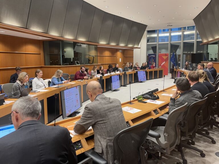 Participants to the Social Europe Conference sitting in a roundtable and discussing